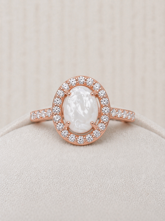 Halo ring in Rose gold, oval shaped with pearled stone